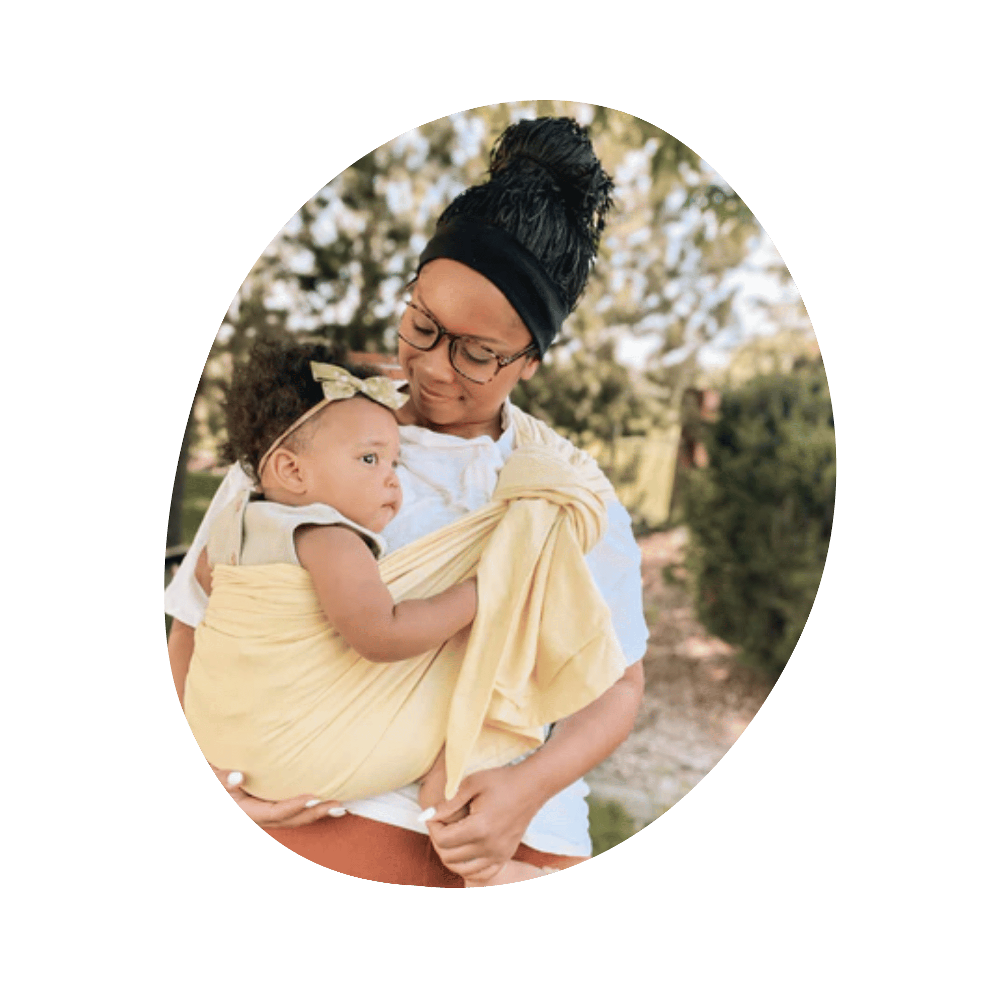 Black mother wearing baby in yellow sling