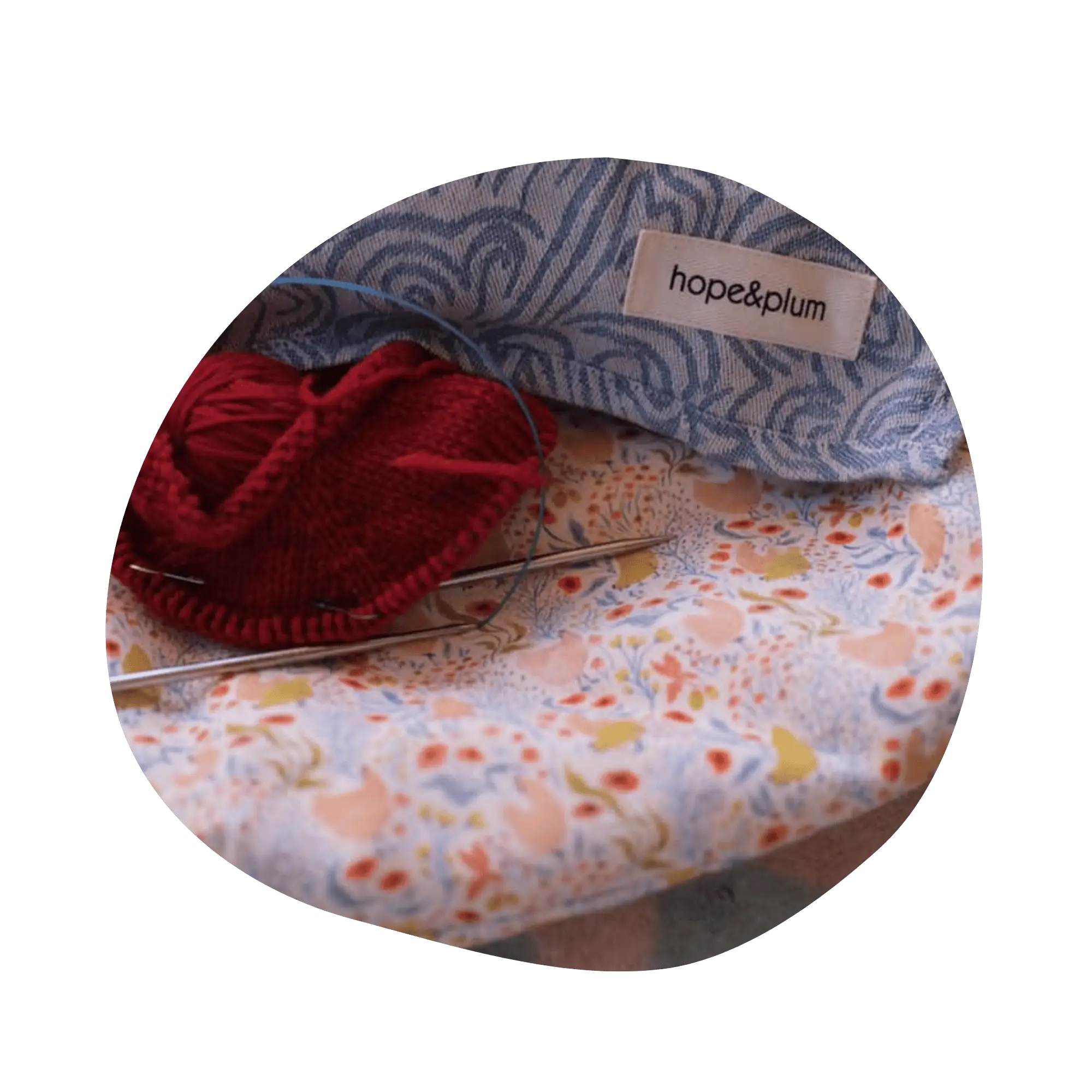 A Ginger flat bottom bag laid flat with a knitting project, needles, and a ring sling on top.