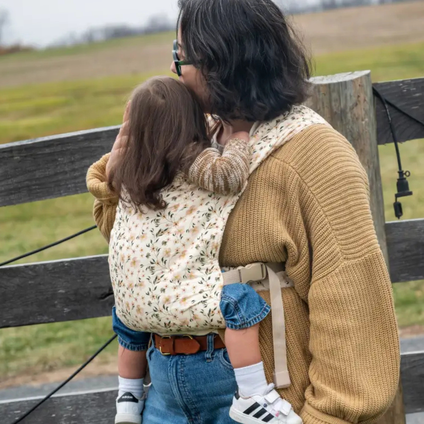 Baby in Lark carrier showing knee-to-knee support and ergonomic positioning