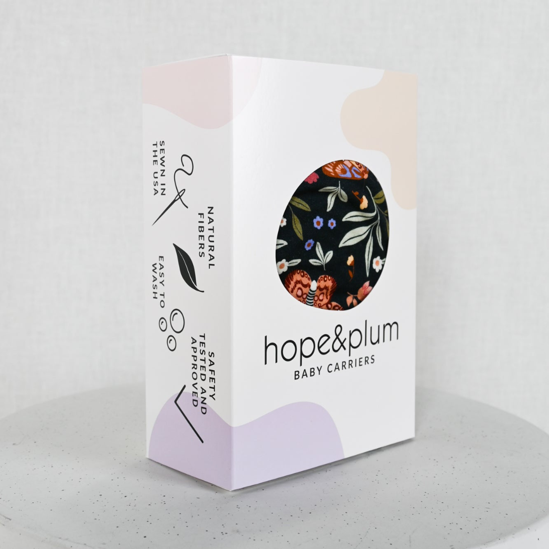 hope&plum baby carriers packaging on a light gray background