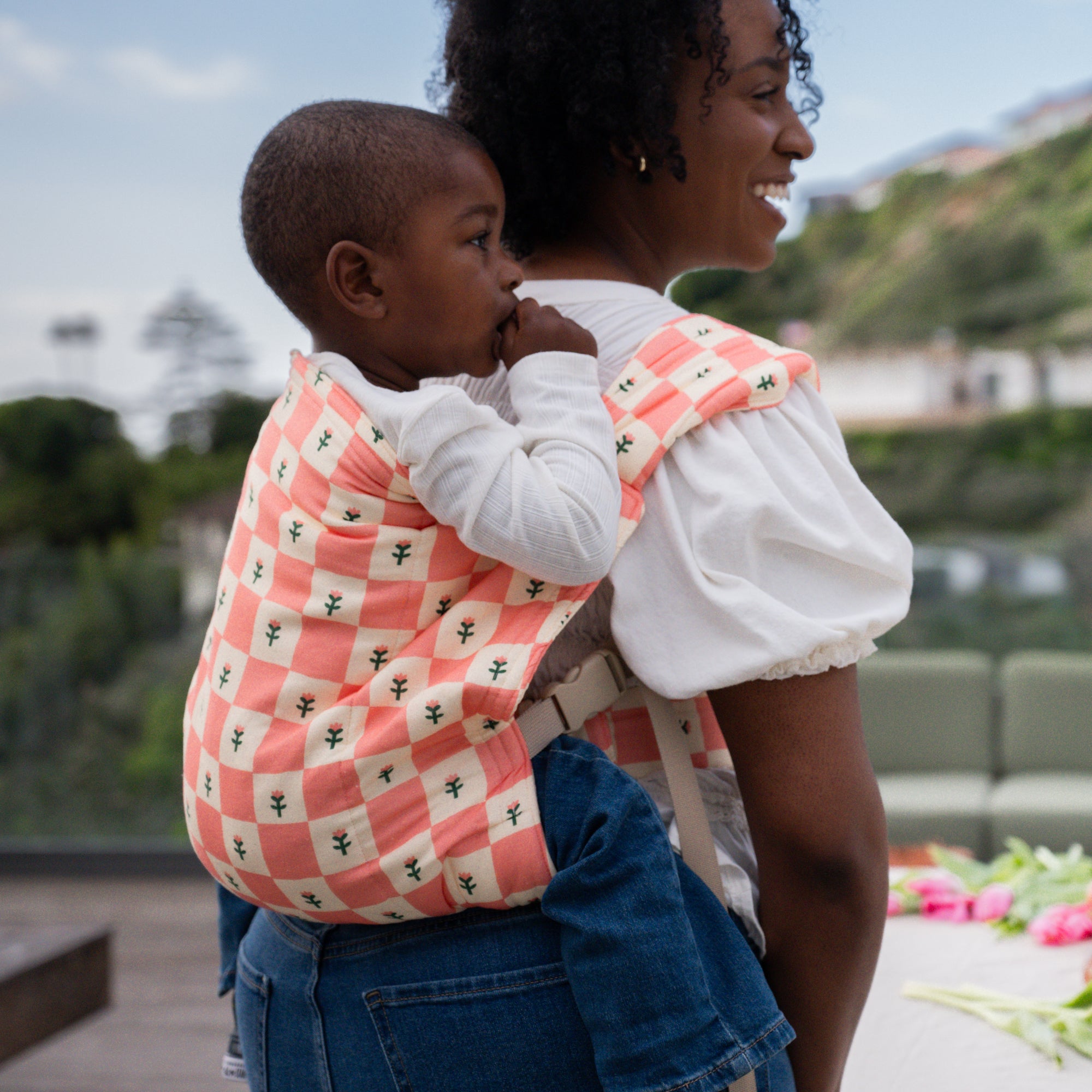 hope&plum Darling Kid Lark toddler carrier coral checkerboard tulip back carry position