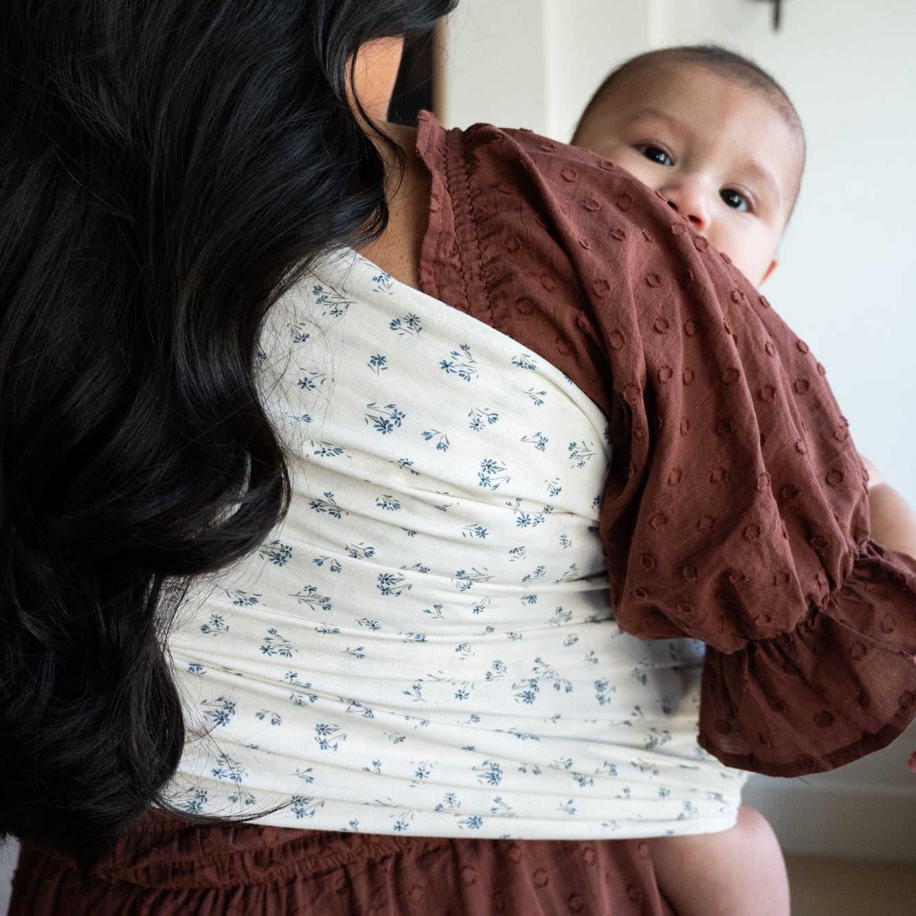 Woman holding a baby in a dainty floral