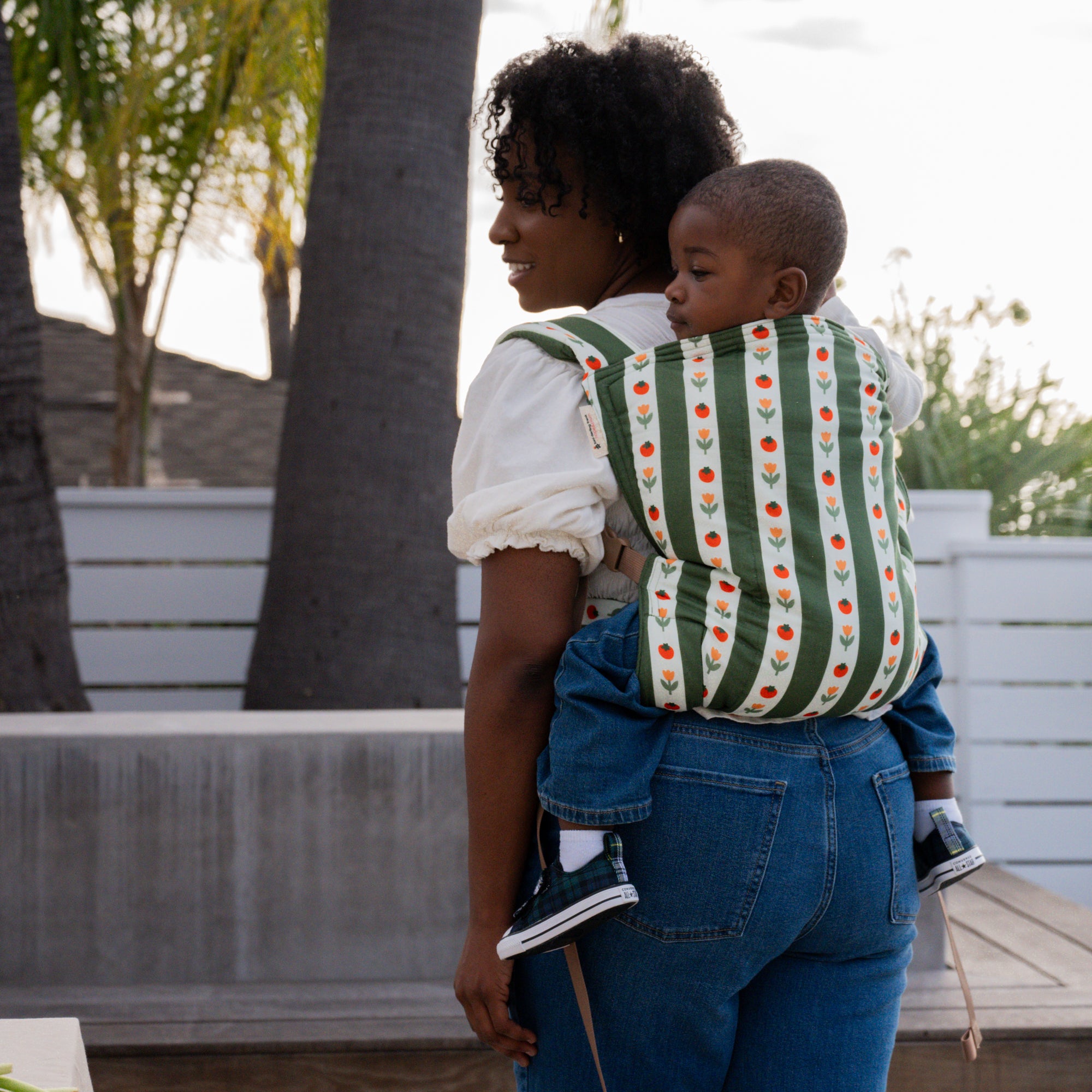 hope&plum Medley Kid Lark buckle toddler carrier olive green stripe with tomatoes and tulips in back carry position