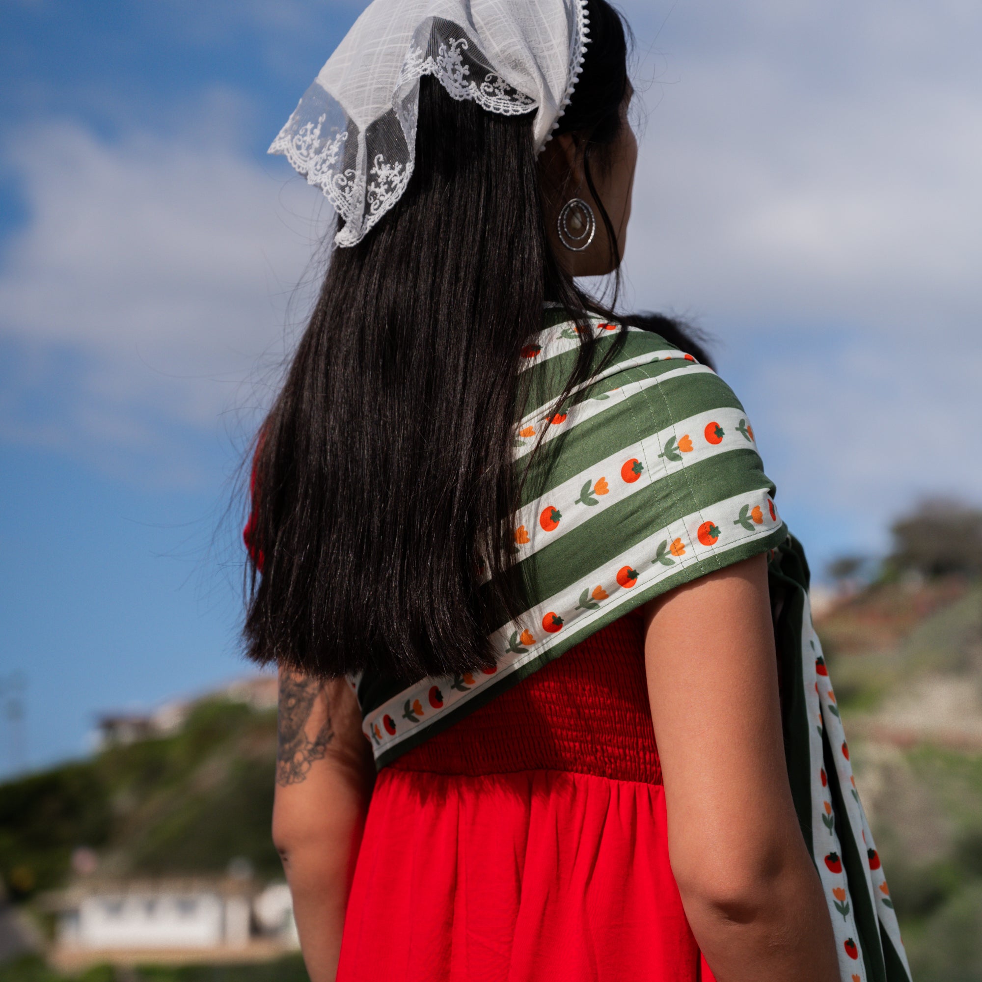 Womans back with hope&plum Medley ring sling deep green stripe tomato and floral print front carry baby