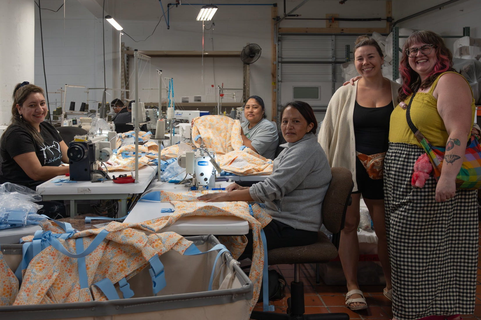Group of women working together in a warehouse setting.