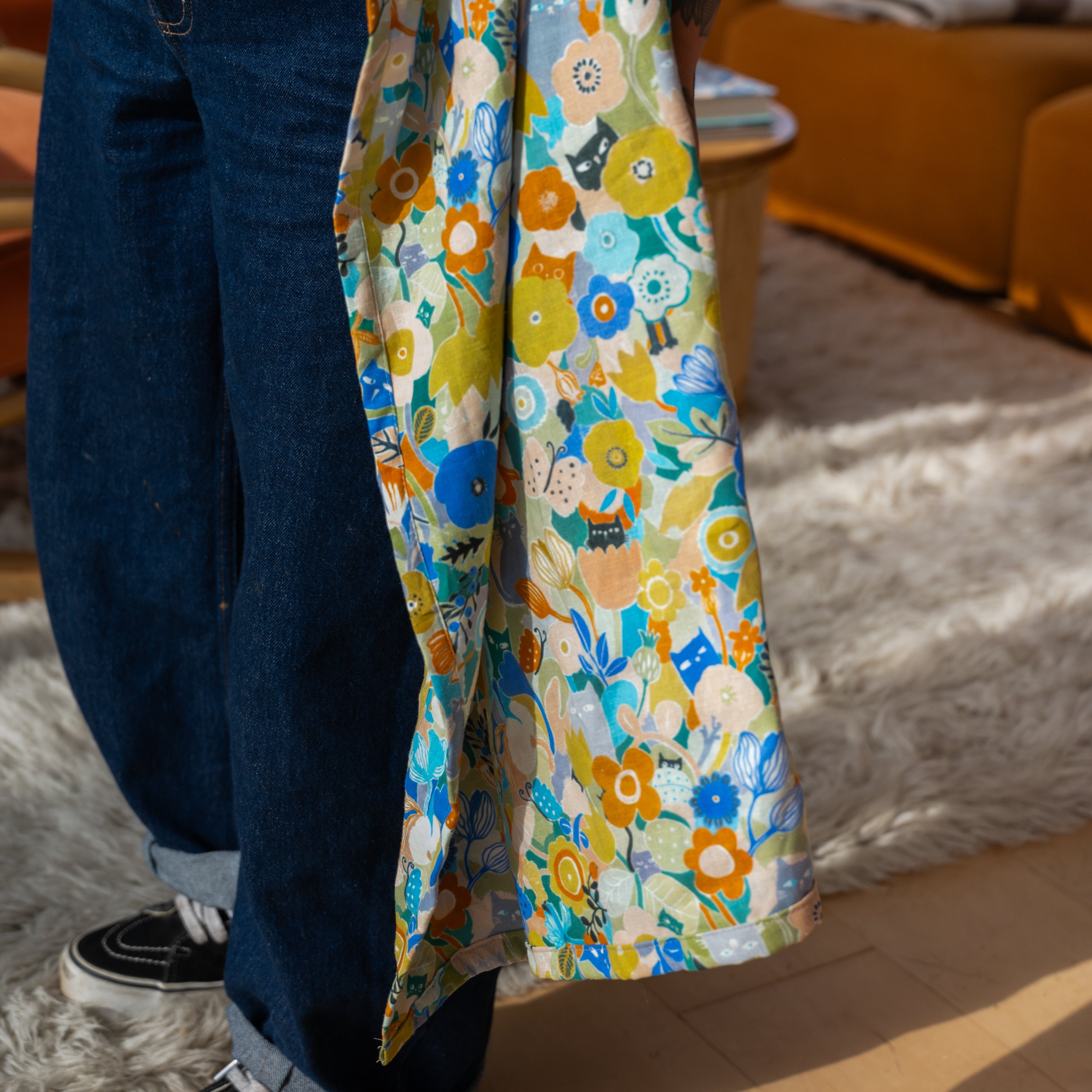 Person wearing a colorful floral ring sling with a blurred background