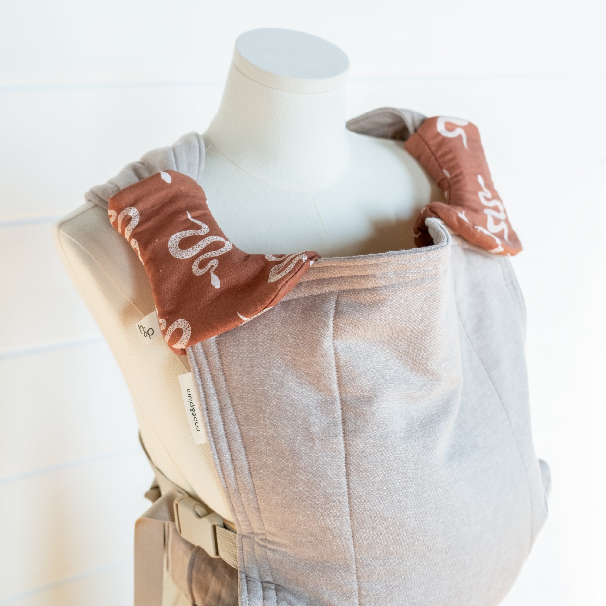 snake pattern drool pads on a mannequin with a white background