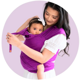 An Asian mother smiling and babywearing her toddler in a purple meh dai carrier
