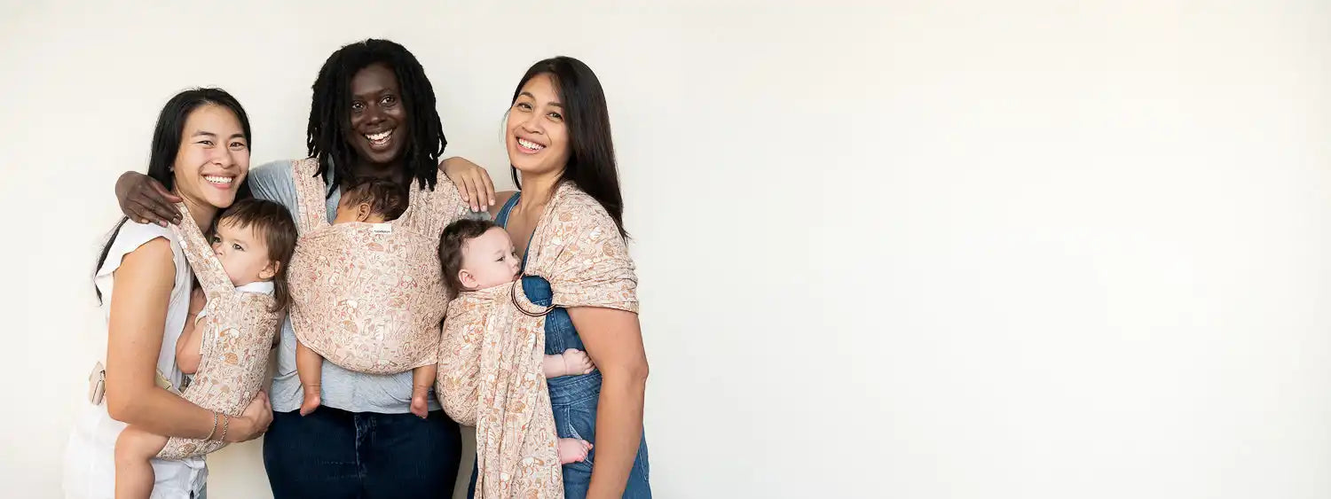 Three women with babies in slings.