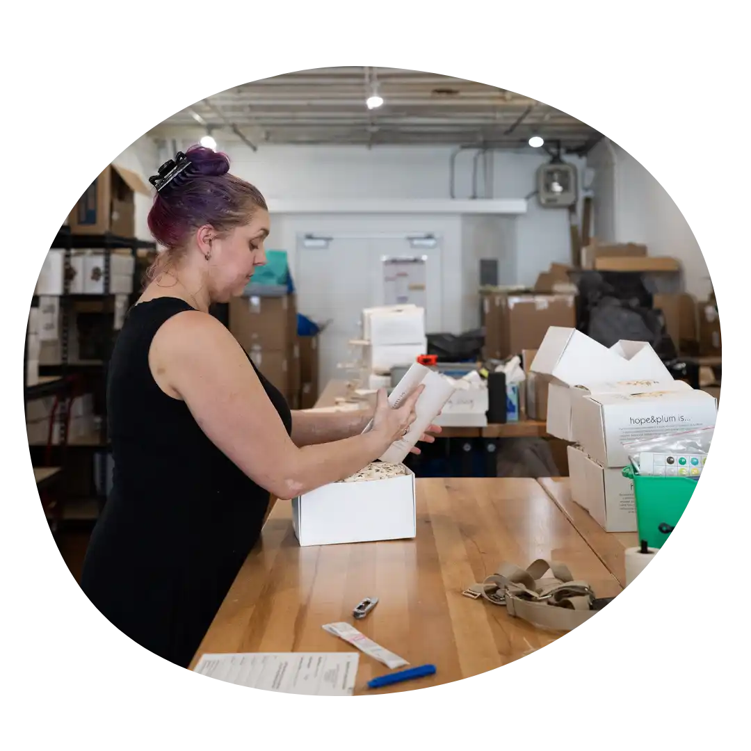 Woman packing a box.