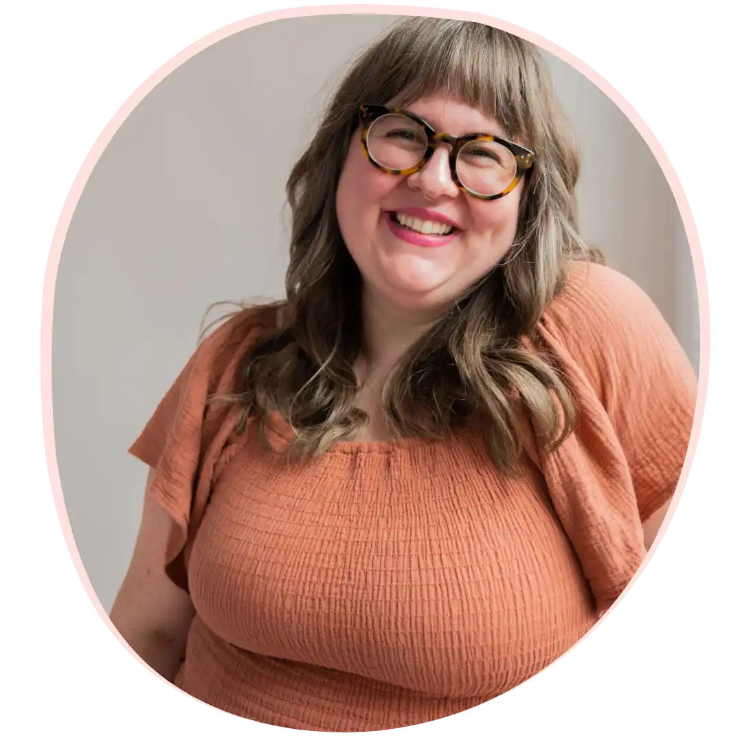 Smiling woman with glasses.