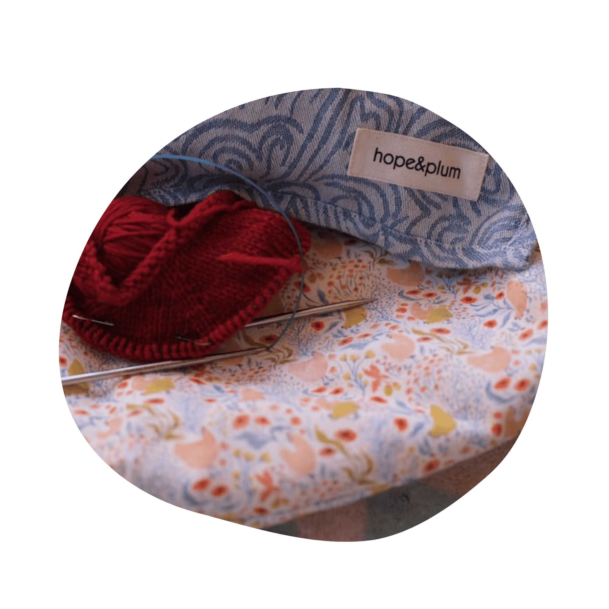 A Ginger flat bottom bag laid flat with a knitting project, needles, and a ring sling on top.
