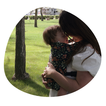 a mom snuggling forward to forward with her baby in a hope&plum night garden lark baby carrier