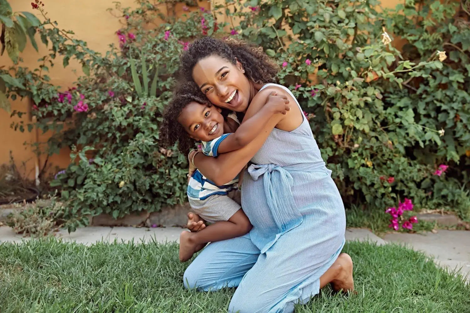 Pregnant woman hugging a toddler