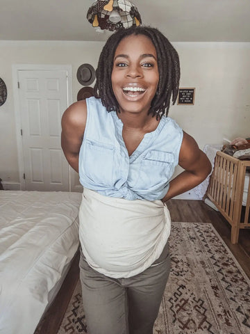 Mother using ring sling as a belly wrap