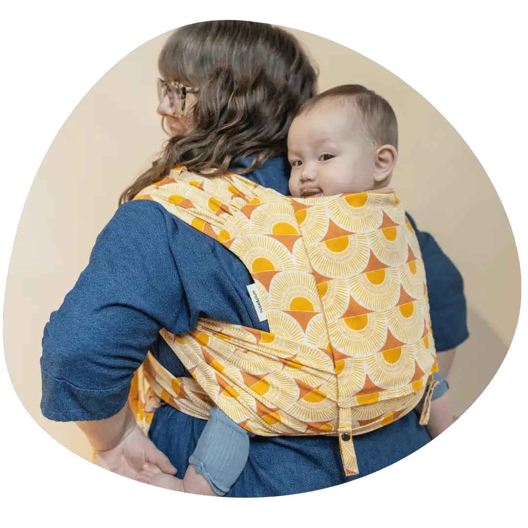 mallory co-founder wearing a baby in a plus size baby carrier meh dai