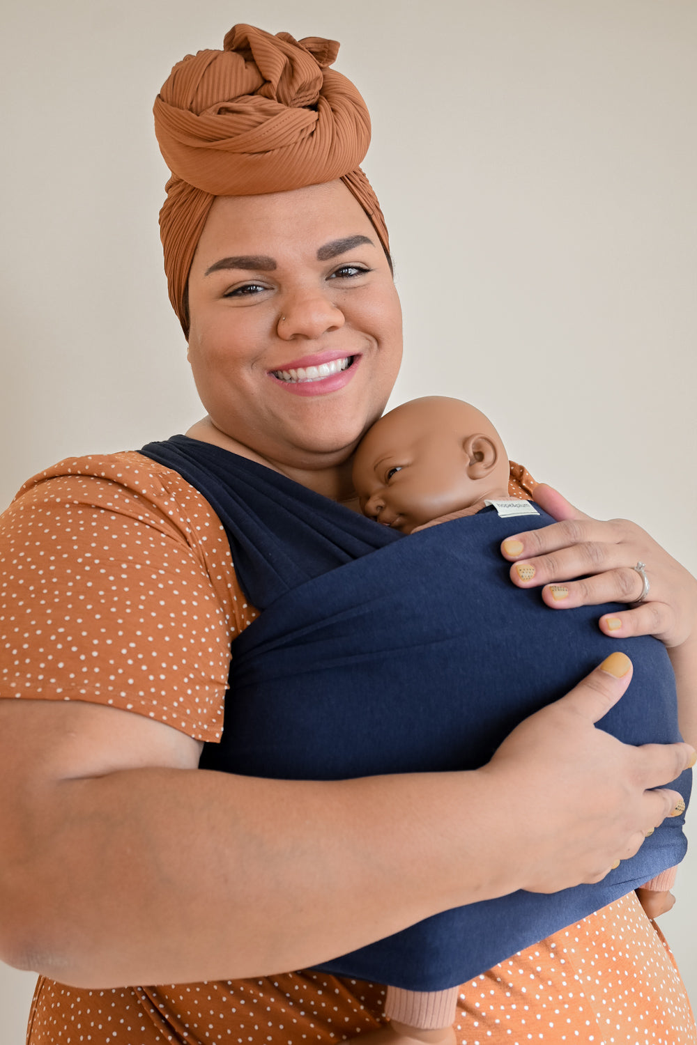 plus-sized parent wearing baby in stretchy wrap