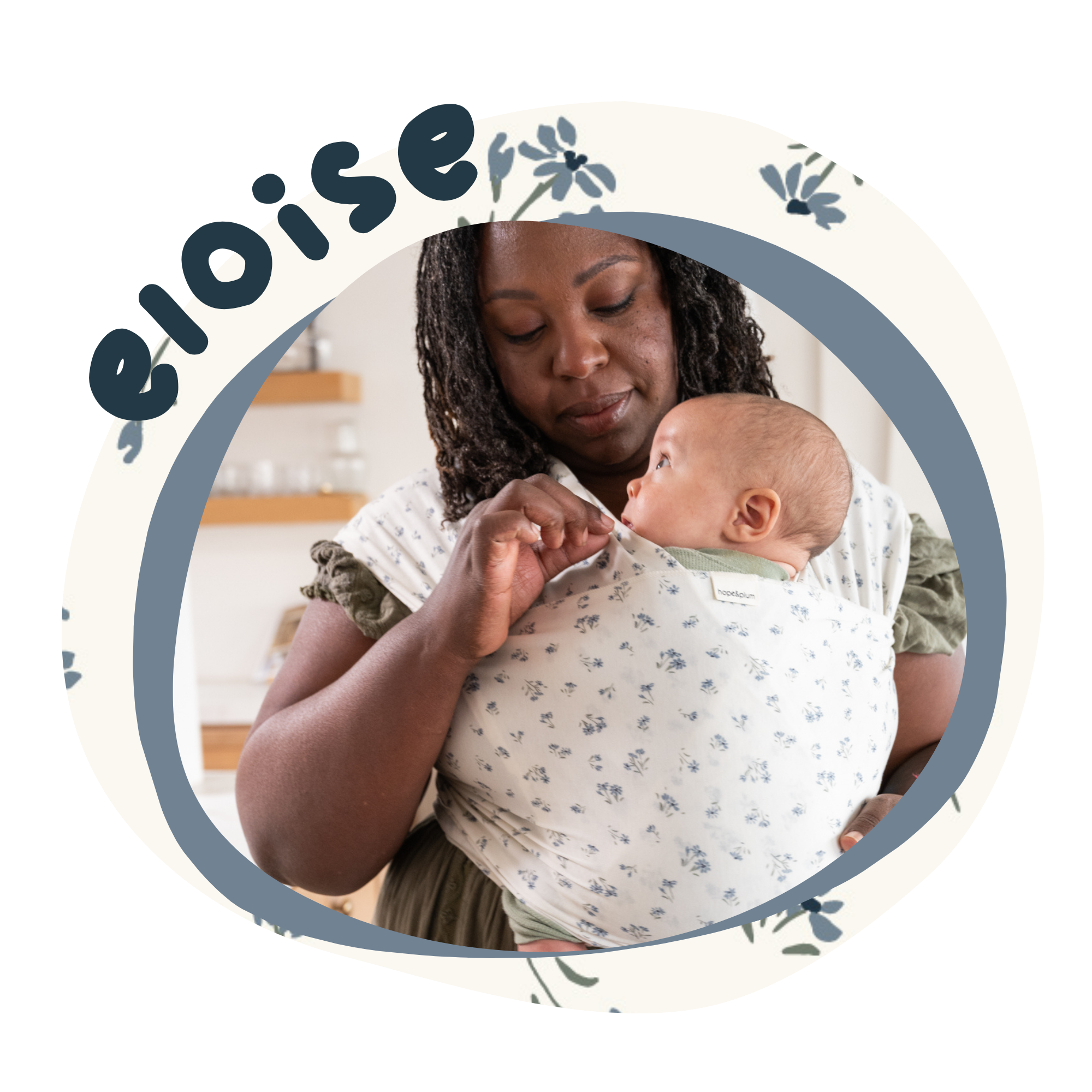 Woman holding a baby in a wrap with 'Eloise' branding.