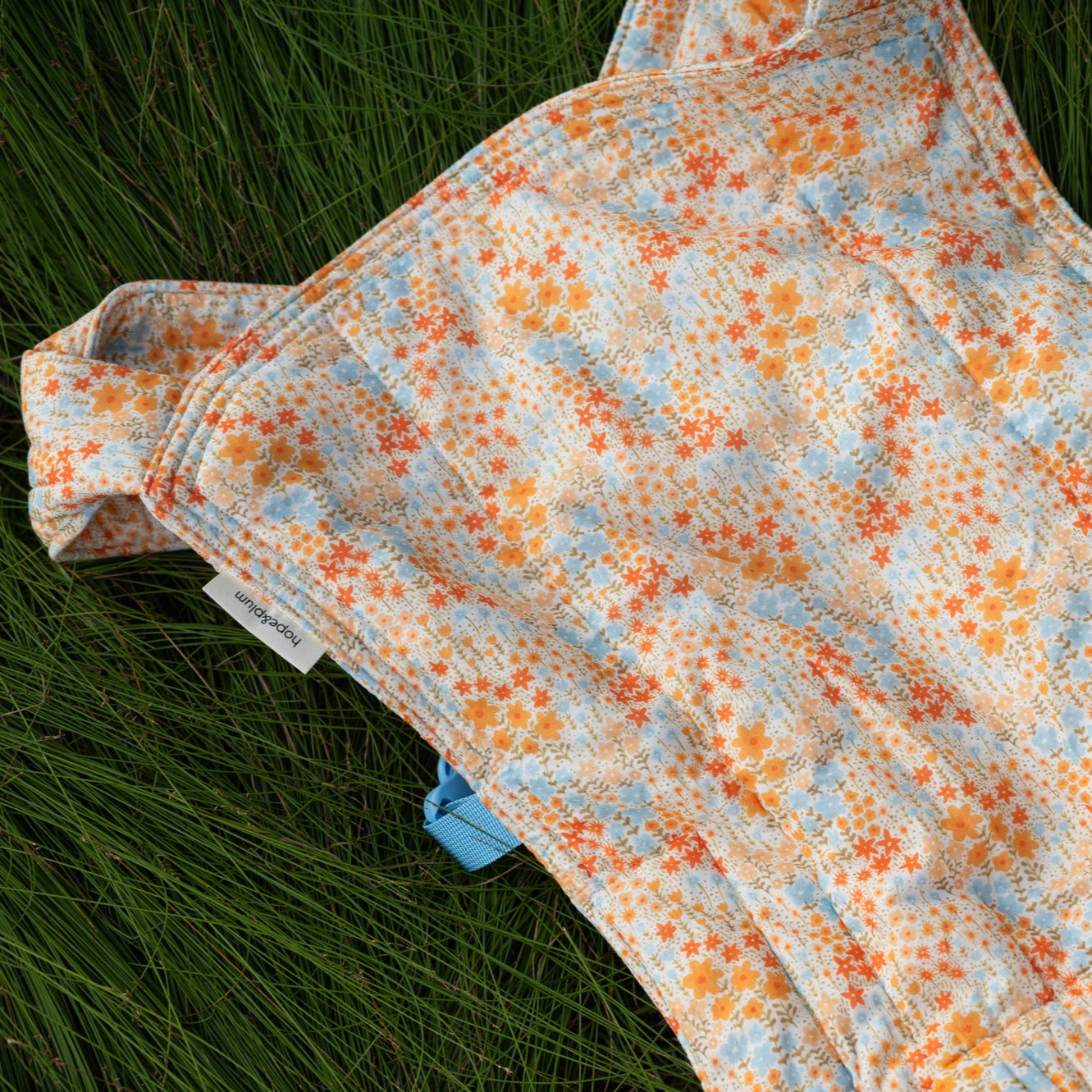 Patterned quilt on a grassy surface