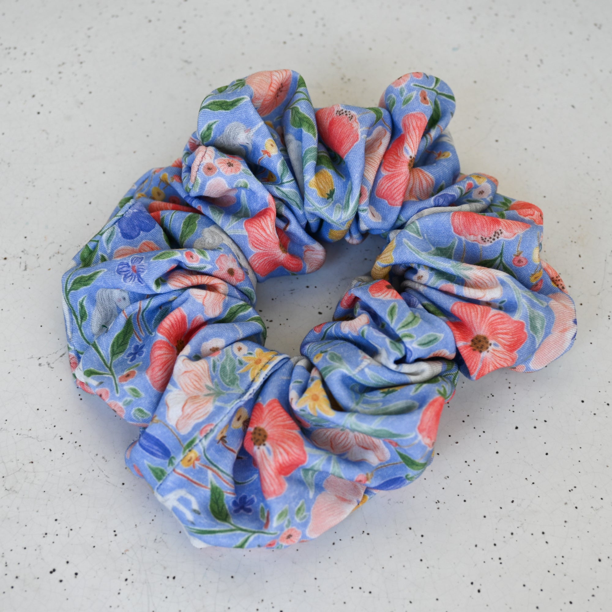 Floral patterned scrunchie on a light gray background