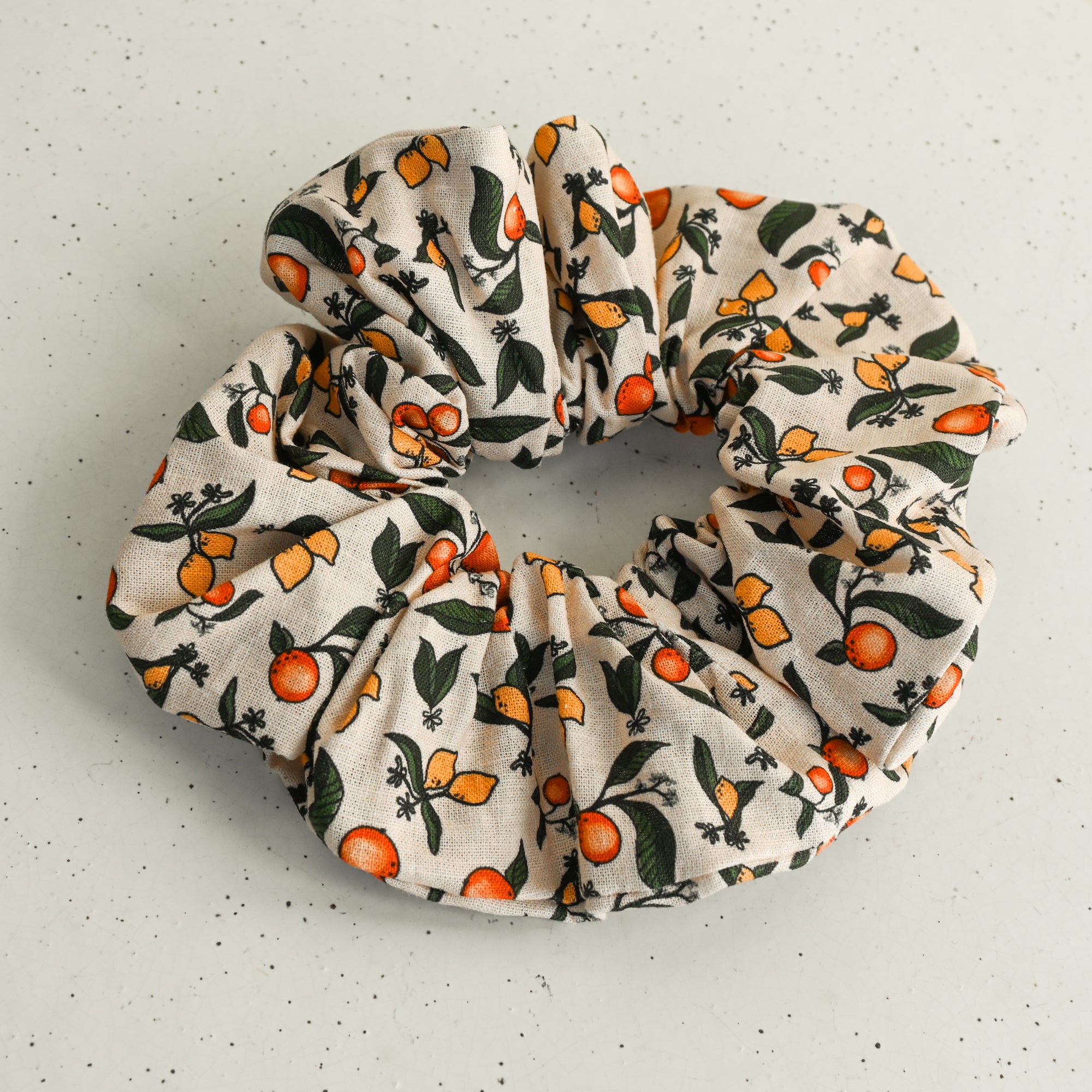 fabric scrunchie with a fruit pattern on a white background