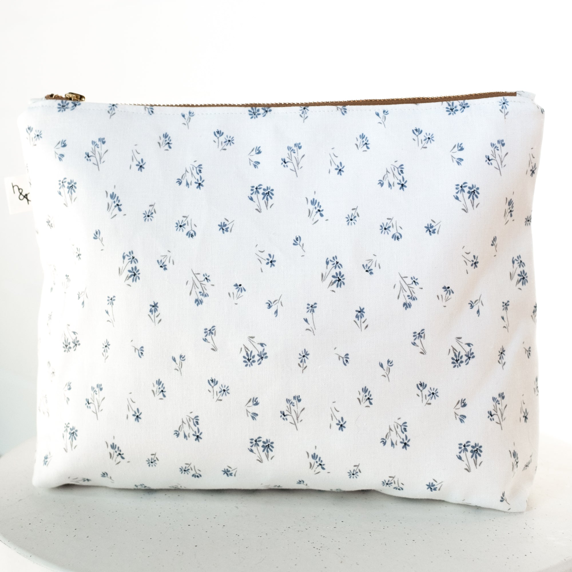 Floral-patterned pouch on a white background