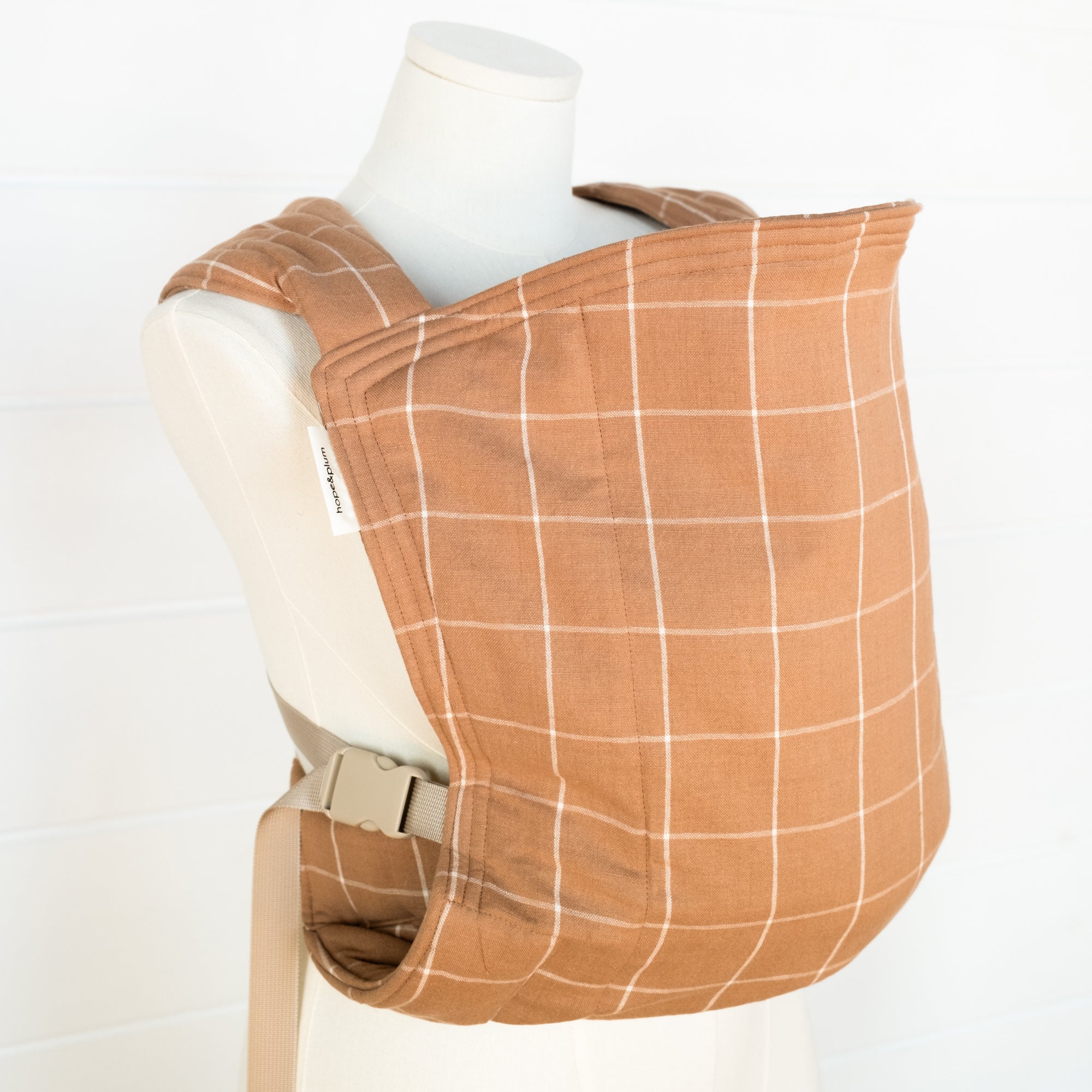 brown baby carrier on a mannequin