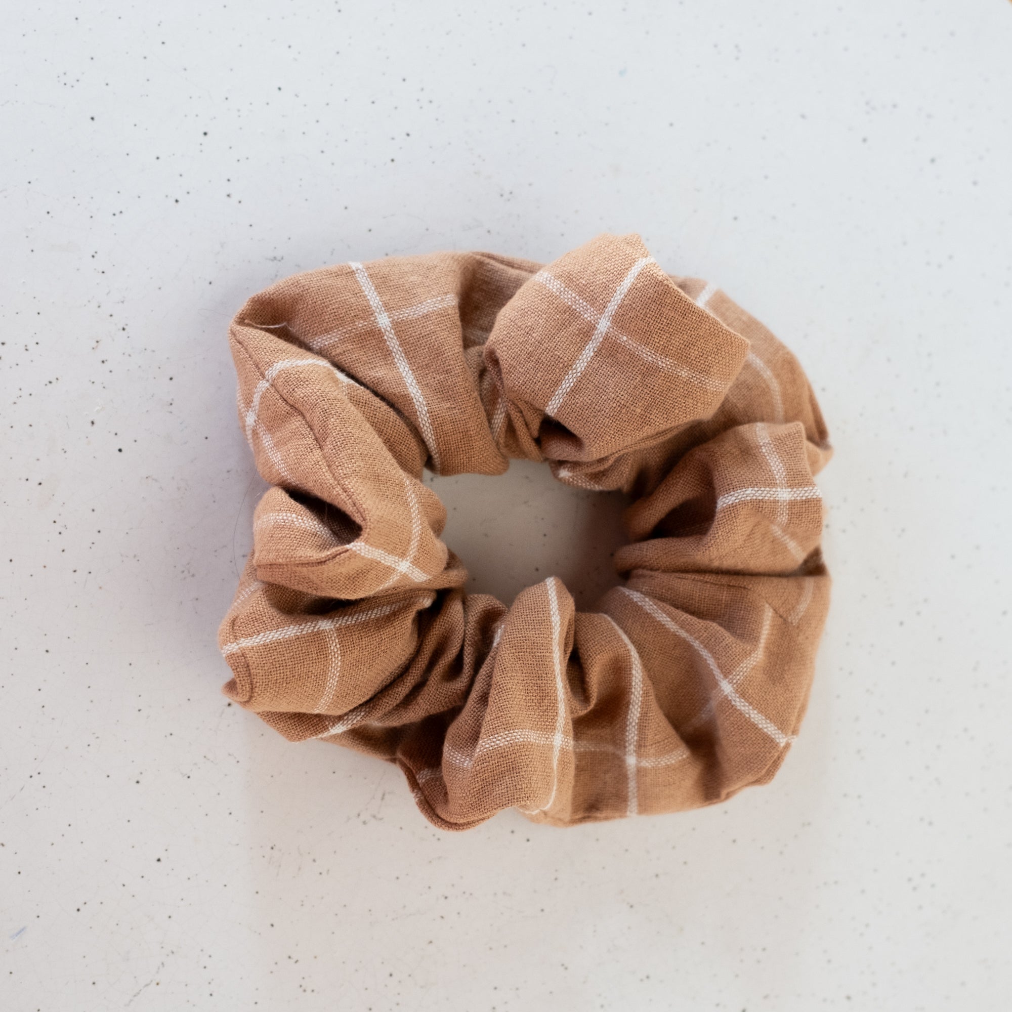 brown plaid patterned scrunchie on a light gray background