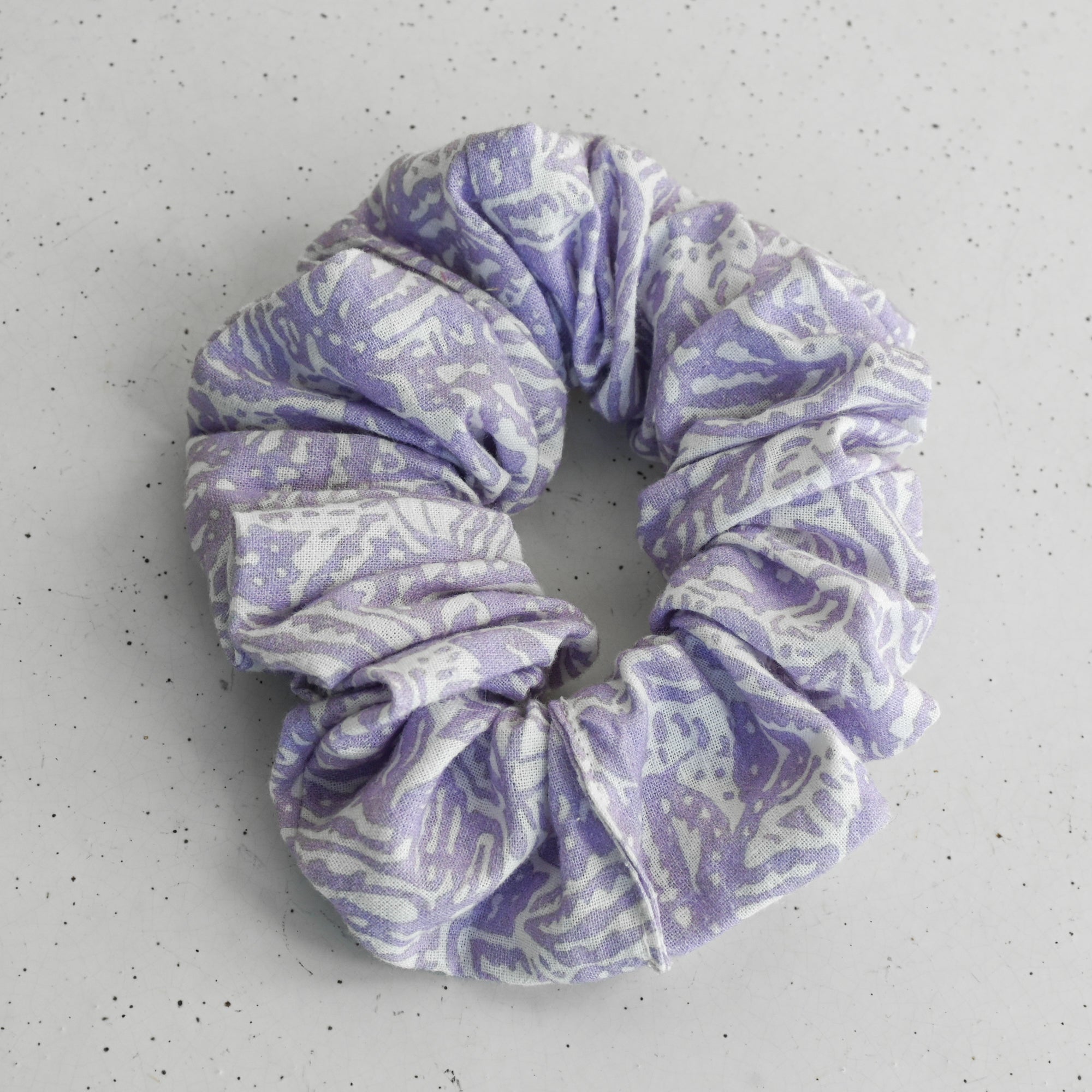 Purple patterned scrunchie on a white background
