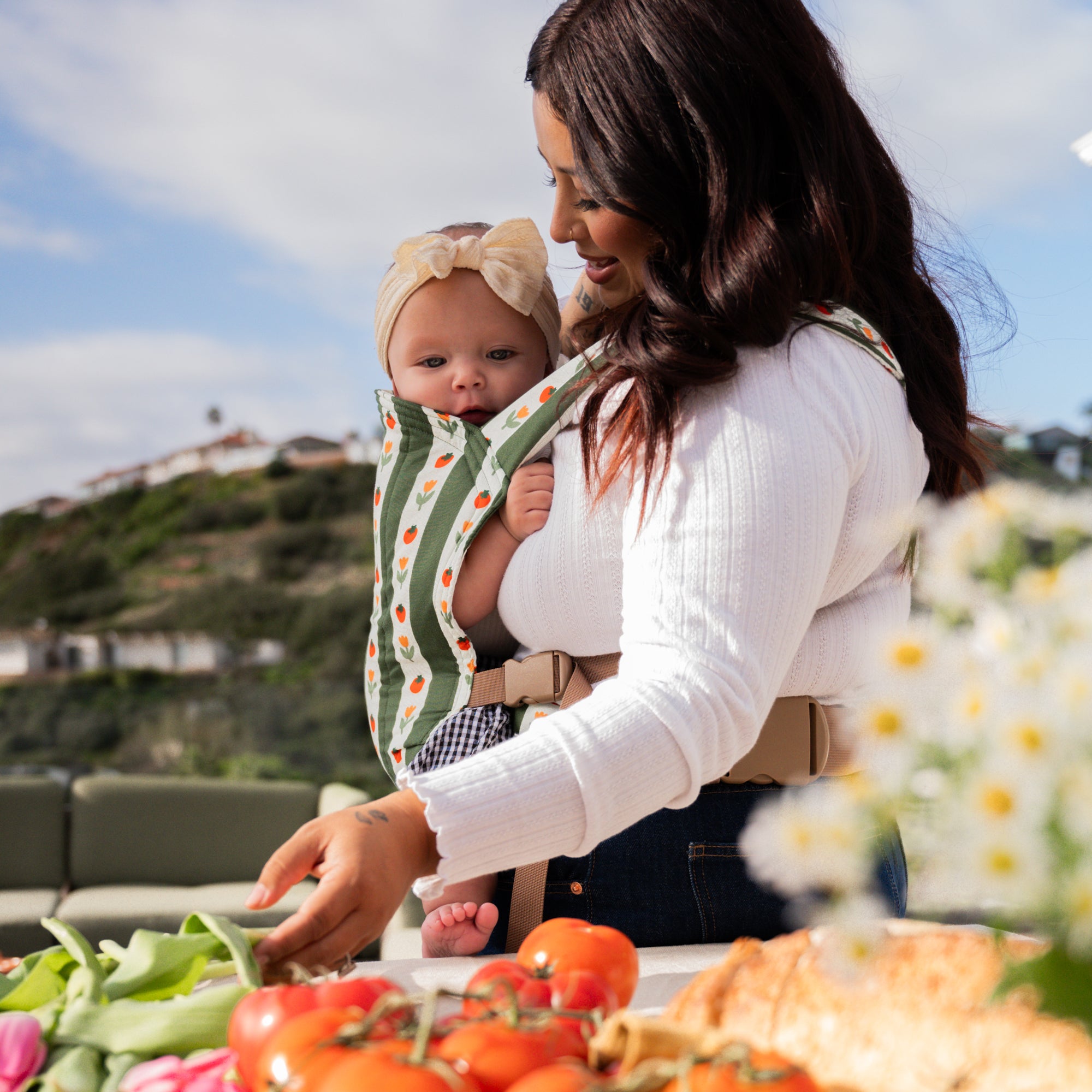hope&plum Medley Lark buckle baby carrier olive green stripe with tomatoes and tulips in front carry position