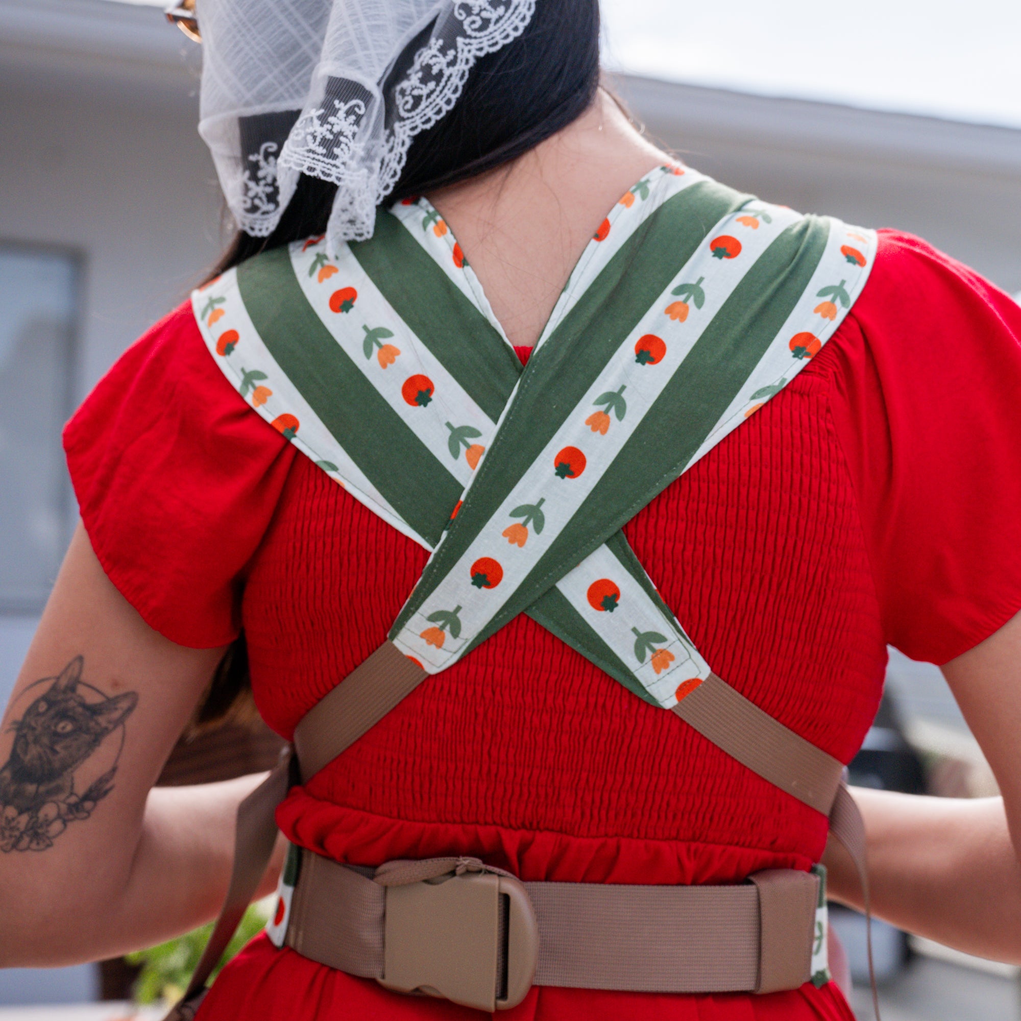 Medley - Sprout Baby Carrier - hope&plum carriers - green and white striped carrier with tomatoes and tulips on the white stripe