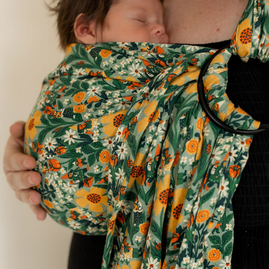 Plus-size mother wearing newborn in plus-size ring sling baby carrier