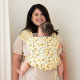 plus-size mother wearing infant in sunflower print meh dai plus size baby carrier