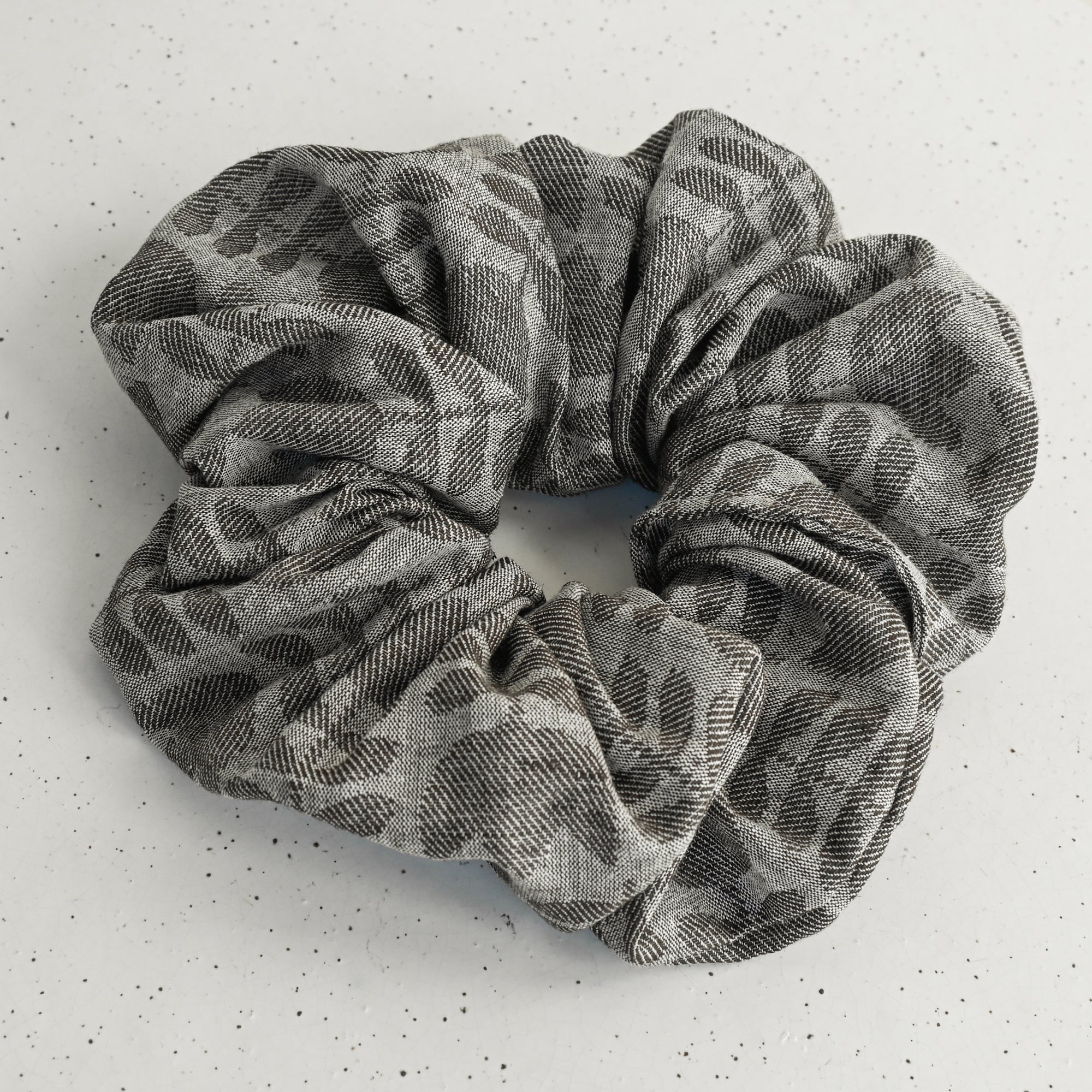 Gray tulip patterned scrunchie on a white background