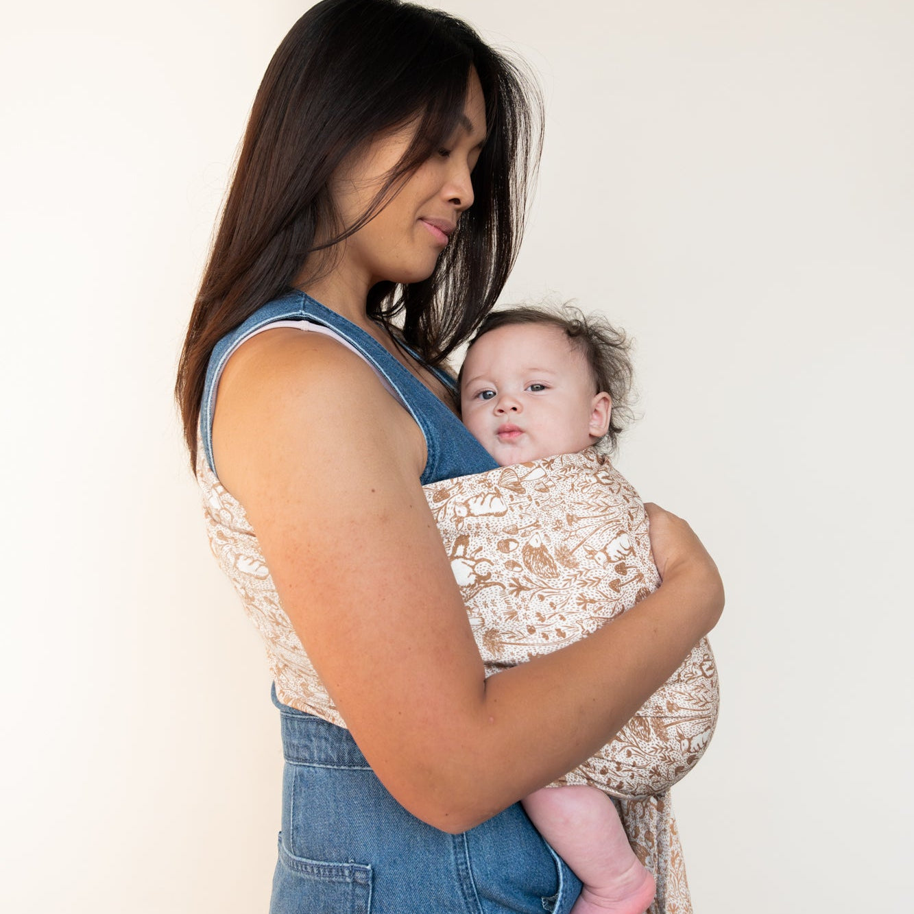 Woman wearing baby in woodland creature ring sling