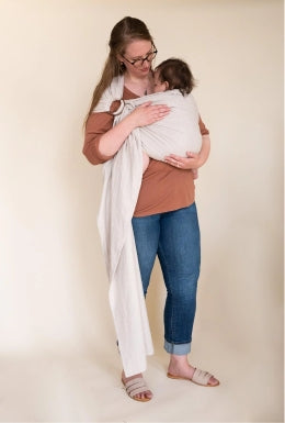 Tall mother wearing baby in ring sling wrap baby carrier