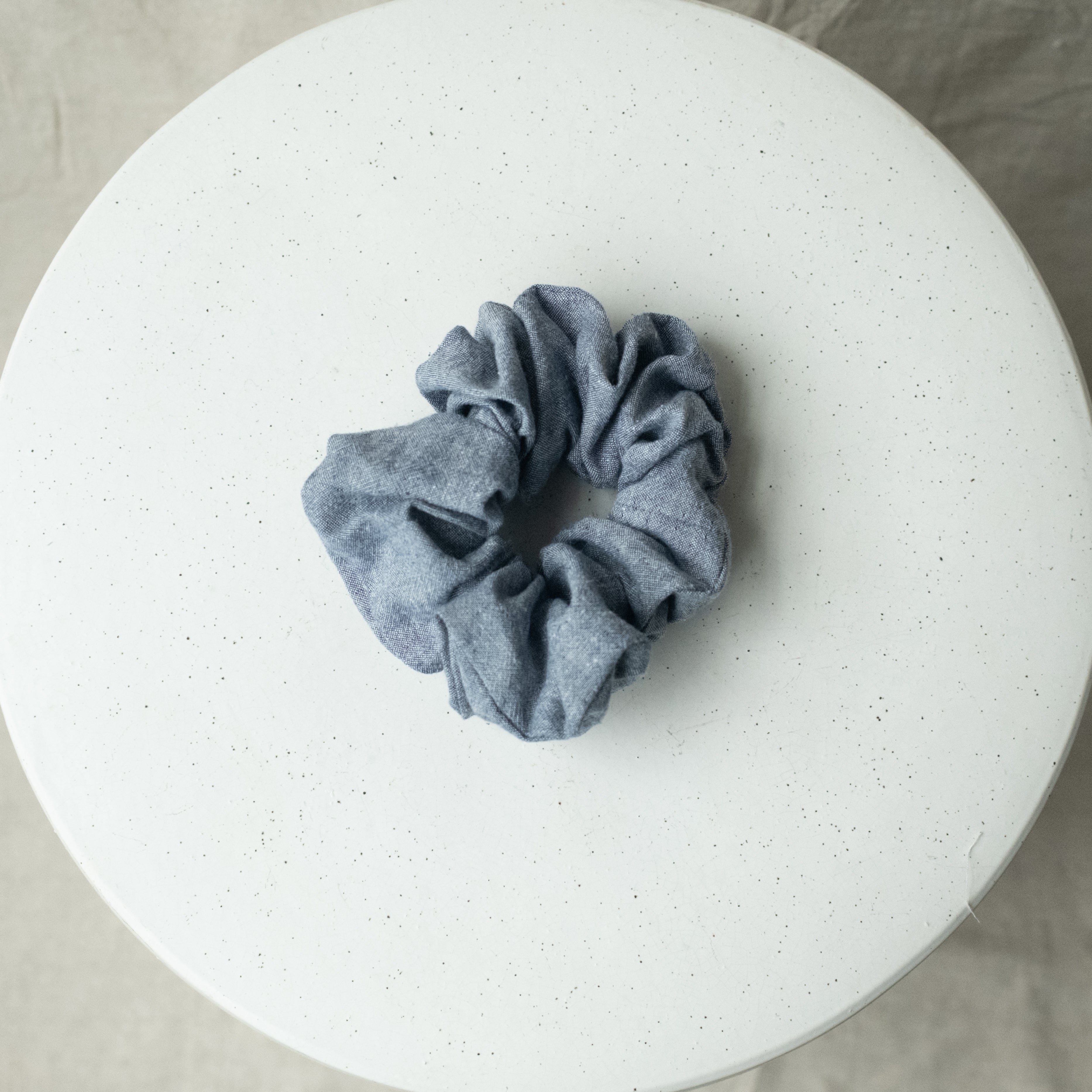 A single oversized scrunchie in blue chambray