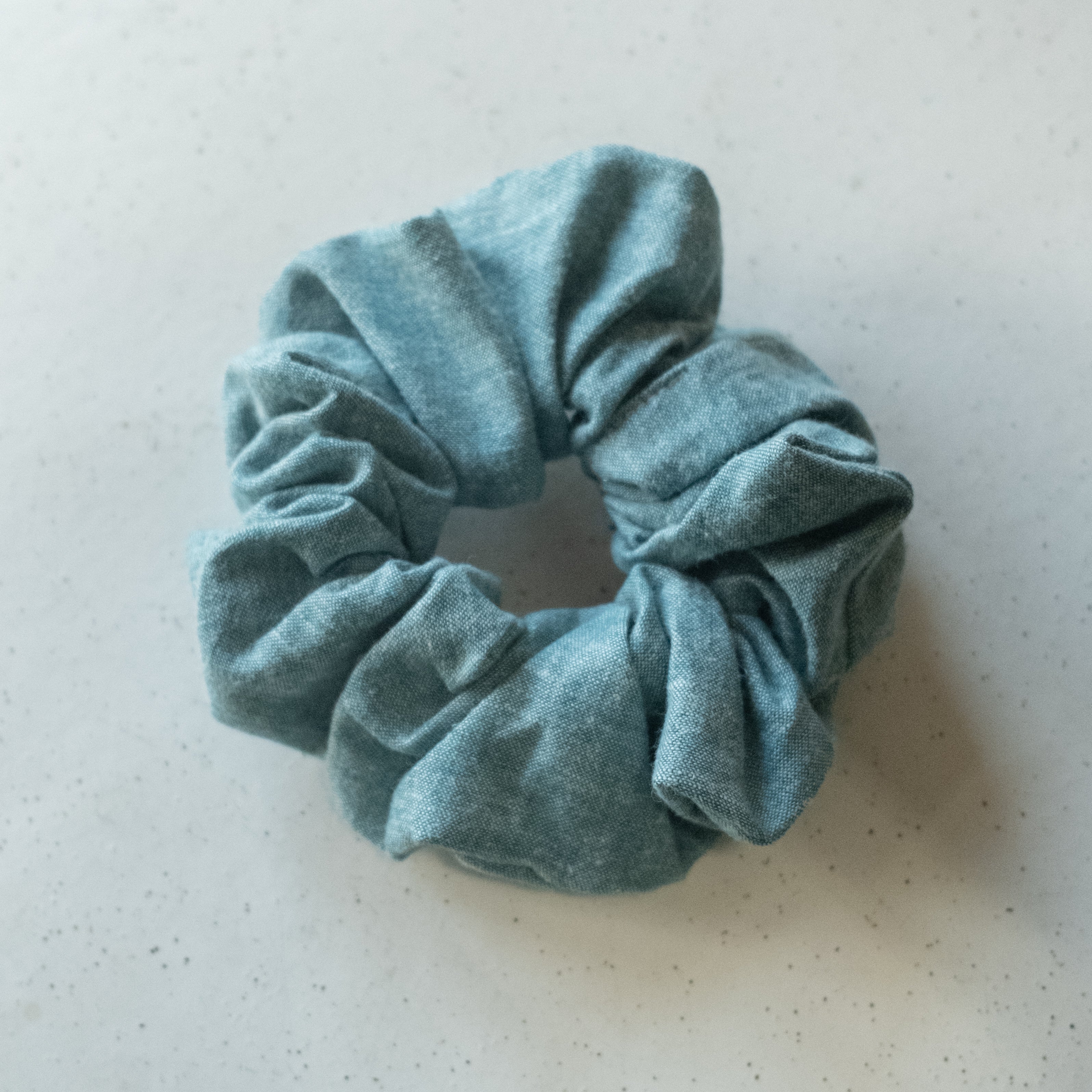 A single oversized scrunchie in muted teal plain woven fabric with a generously gathered, voluminous silhouette.