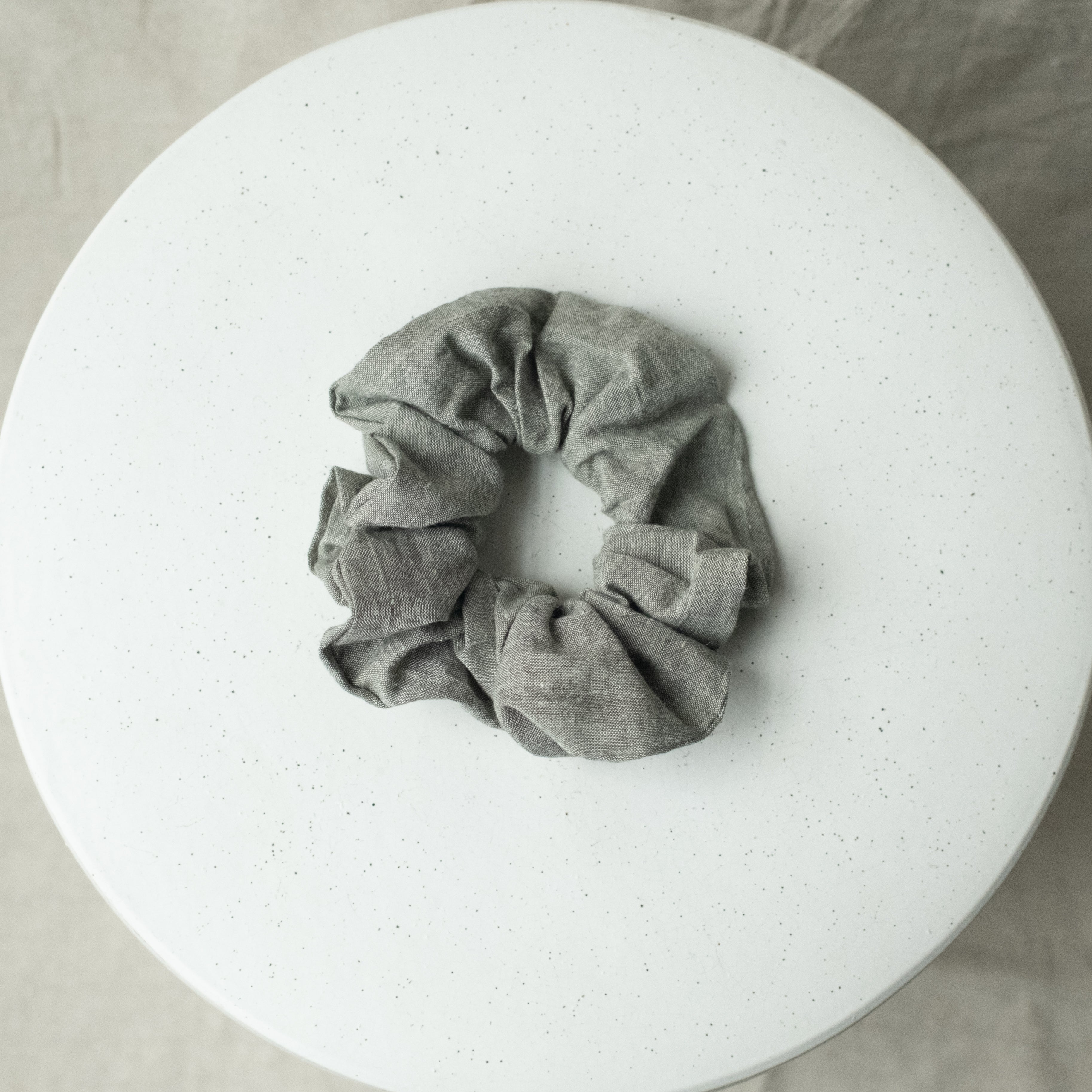A single oversized scrunchie in charcoal chambray