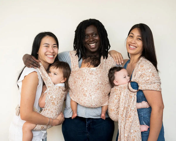Three women with babies in patterned slings.