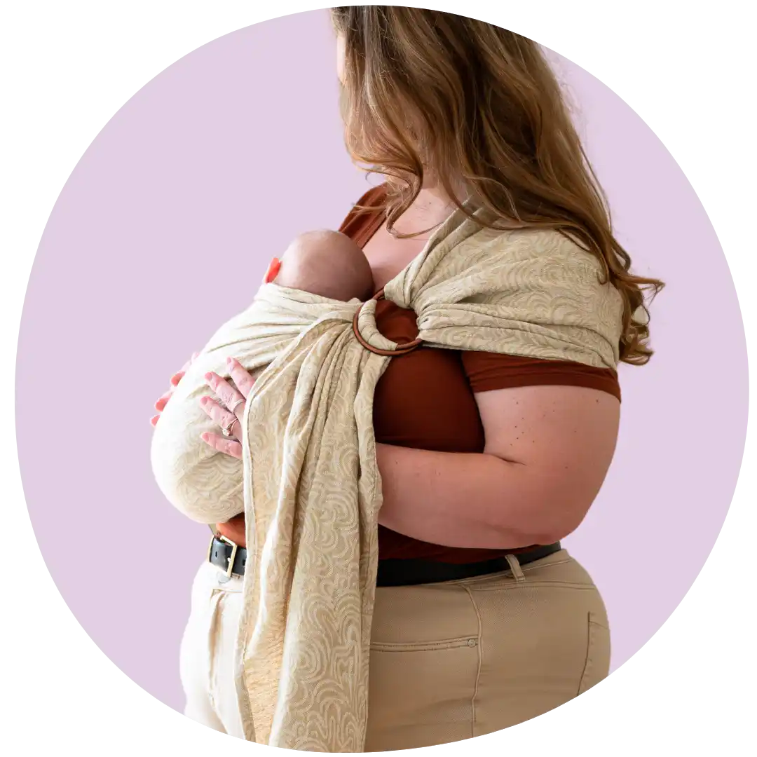 Woman carrying baby in ring sling.
