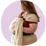 Woman carrying baby in ring sling.